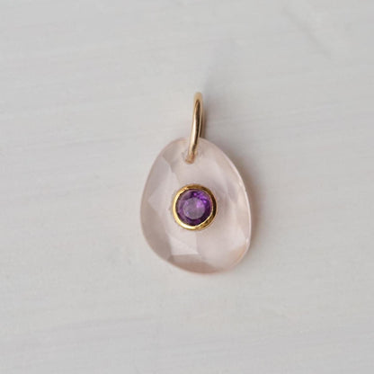 Roselight pendant featuring rose quartz and amethyst gemstones, crafted by Earthly Abundance, showcasing the pendant's elegant design.
