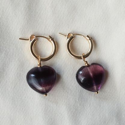 Earthly Abundance fluorite heart hoop earrings featuring vibrant green and purple fluorite stones set in silver hoops.