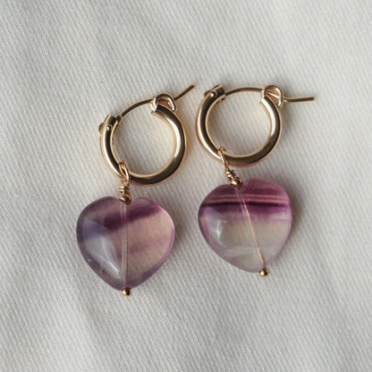 Earthly Abundance fluorite heart hoop earrings featuring vibrant green and purple fluorite stones in elegant hoop design.