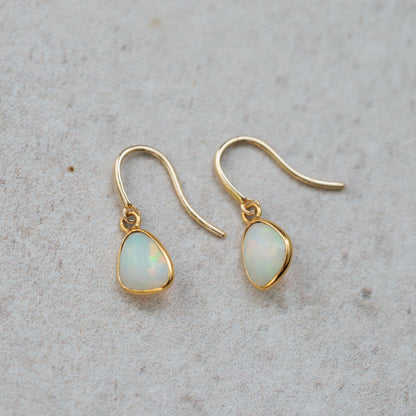 Ethiopian Opal earrings in 14K gold with elegant, effortless design featuring vibrant, iridescent opals and gold hooks.