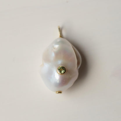 Lumen Baroque Pearl and Peridot necklace by Earthly Abundance featuring irregular pearls and vibrant green peridot gemstones.