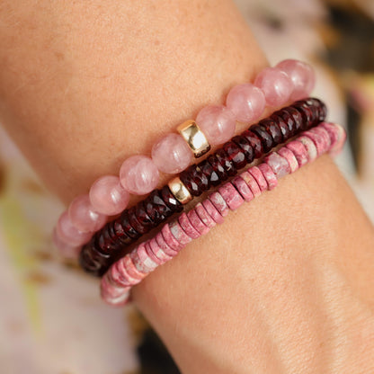 Earthly Abundance garnet Heishi bracelet with small red gemstone beads and elastic band, close-up view of the jewelry.