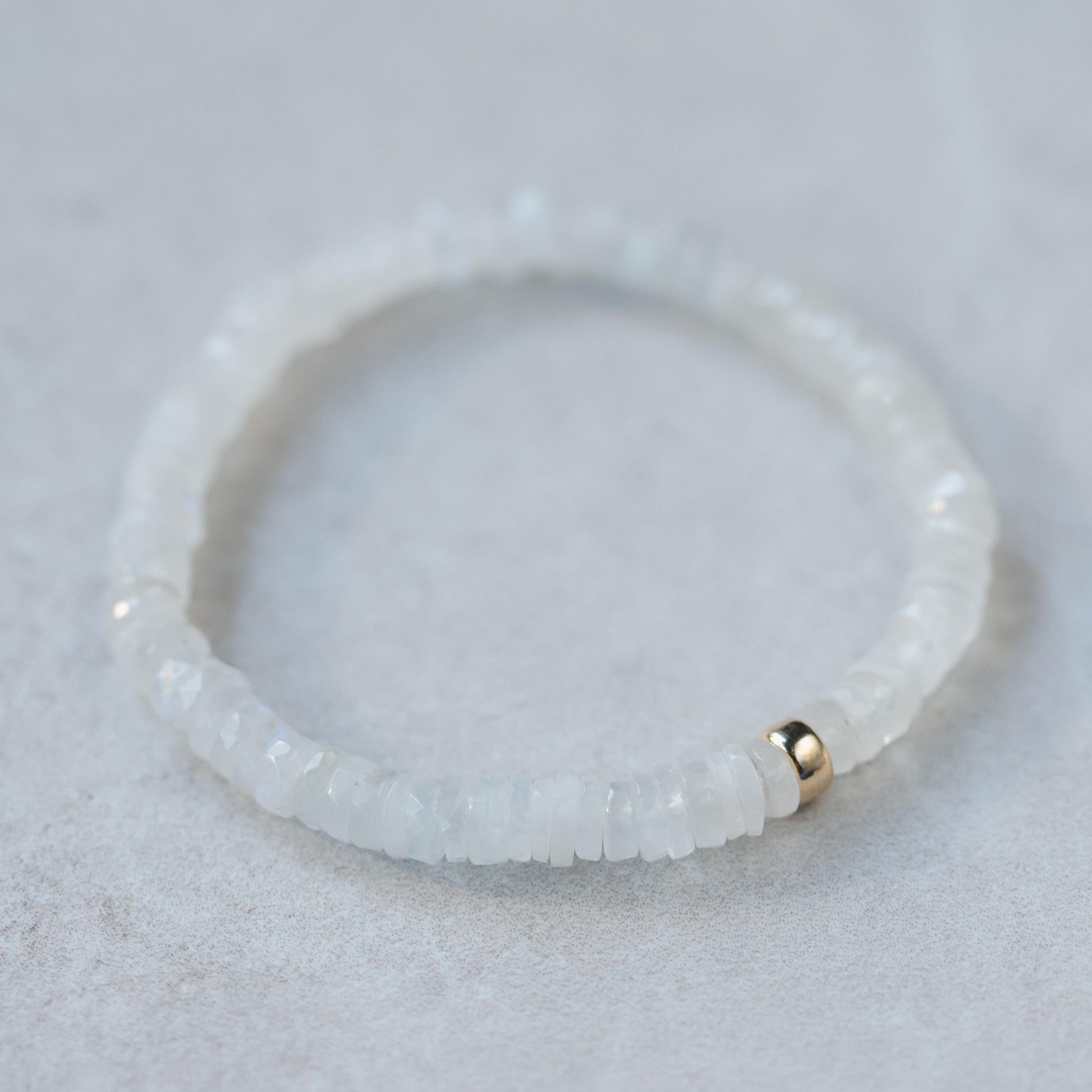 Rainbow Moonstone bracelet with celestial-themed beads from Earthly Abundance, featuring moon and star accents.