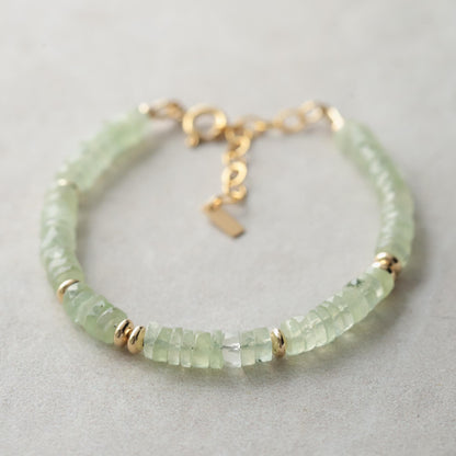 Prehnite Glow bracelet featuring smooth green gemstones on an elastic band, designed by Earthly Abundance.