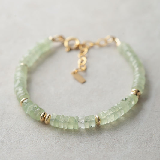 Prehnite Glow bracelet featuring smooth green gemstones on an elastic band, designed by Earthly Abundance.