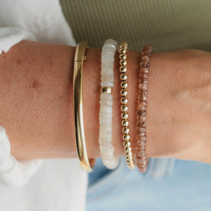 Earthborn Clarity Andalusite bracelet featuring polished stones on a delicate elastic cord, showcasing vibrant earthy tones.
