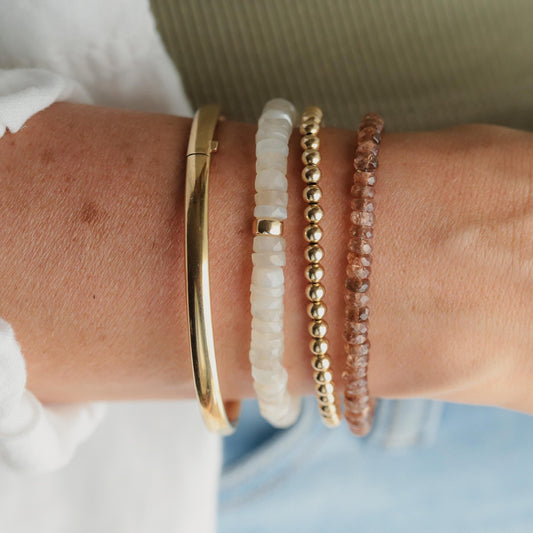 Earthborn Clarity Andalusite bracelet featuring polished stones on a delicate elastic cord, showcasing vibrant earthy tones.