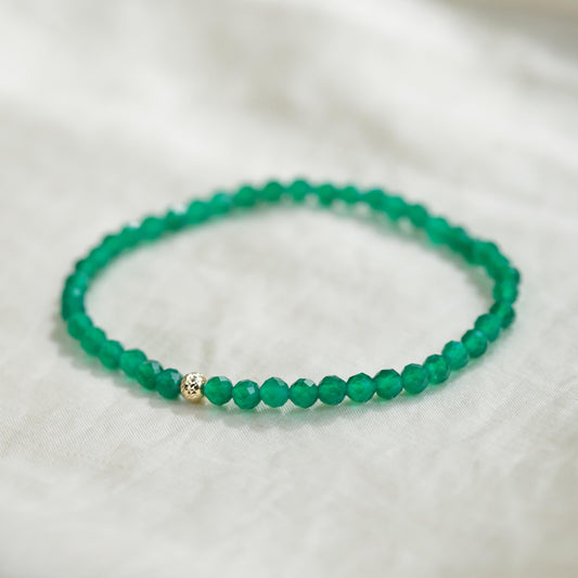 Green Onyx bracelet featuring polished beads from Earthly Abundance, displayed in a close-up shot highlighting its vibrant color and craftsmanship.