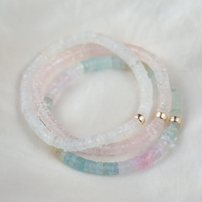 Rainbow Moonstone bracelet from Earthly Abundance featuring celestial-themed beads and a vibrant, iridescent rainbow glow.