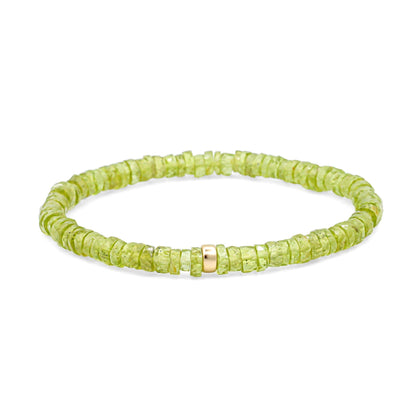 Positive Energy Peridot Heishi Bracelet by Earthly Abundance featuring small green gemstone beads on a stretchy cord.