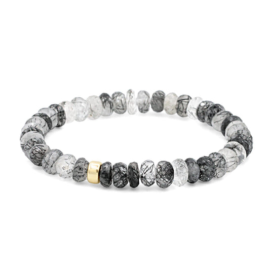 Faceted black rutilated quartz rondel gemstone from Earthly Abundance showcasing its dark, smoky appearance with golden rutile inclusions.
