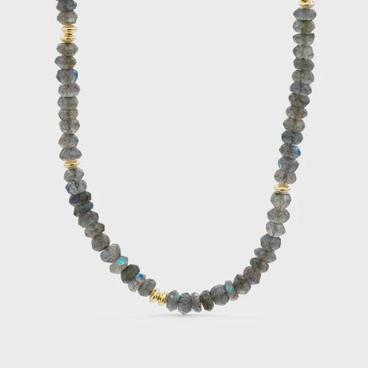 Labradorite power necklace by Earthly Abundance featuring a polished labradorite pendant on a cord, showcasing iridescent blue and green hues.