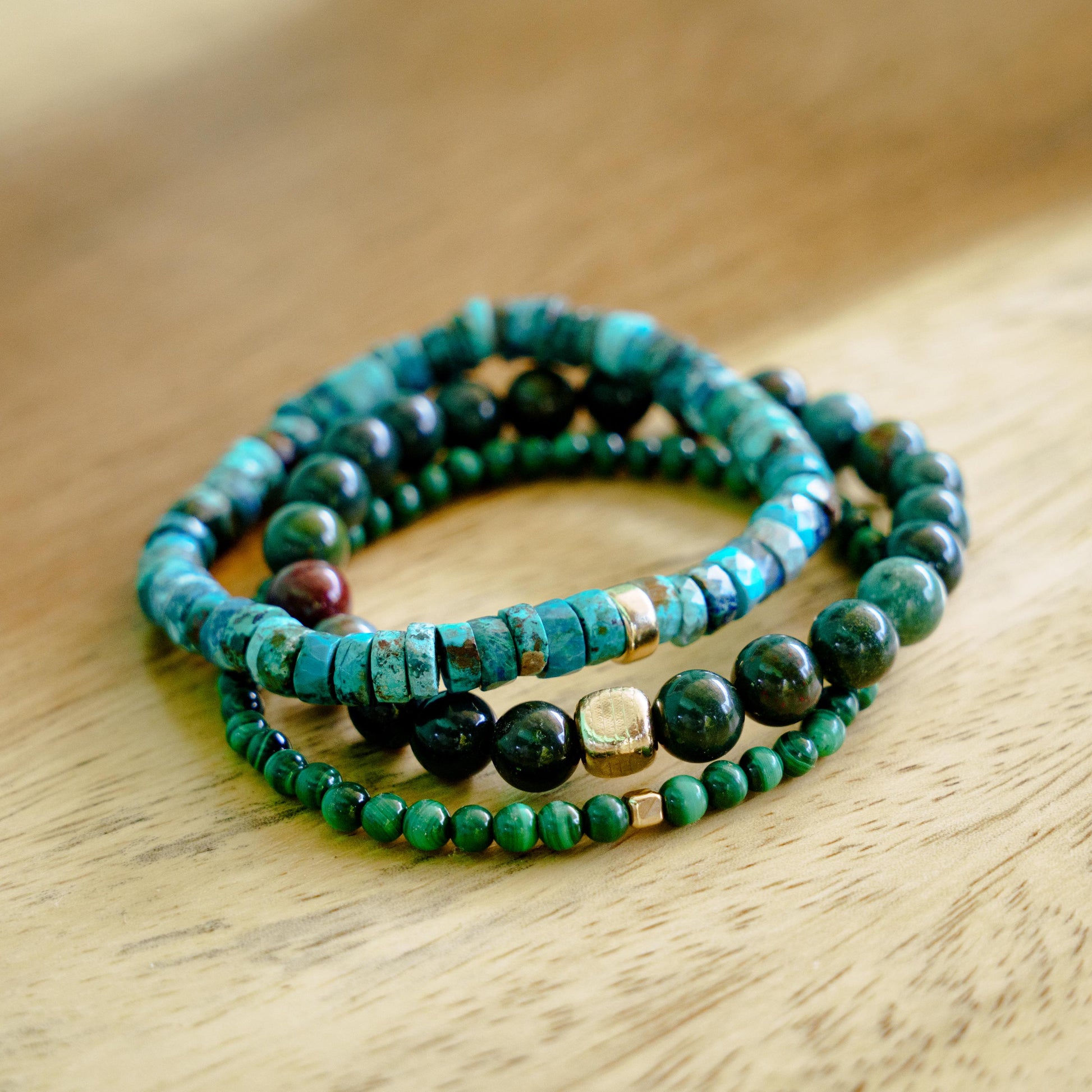Earthly Abundance Bloodstone bracelet featuring polished bloodstone beads on an elastic cord, displayed on a neutral background.