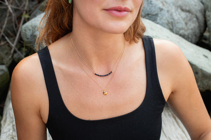 14K gold-filled Sapphire Line Necklace from Earthly Abundance featuring a delicate chain with a row of blue sapphires.