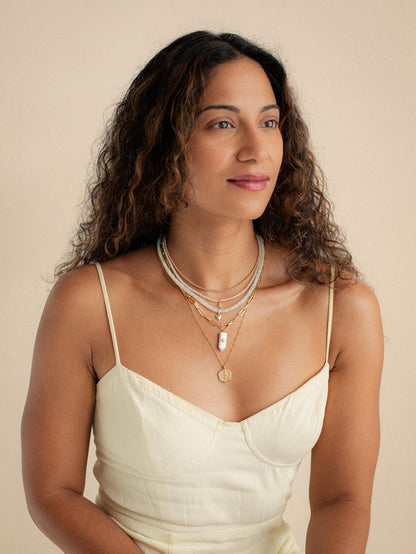Luminous Path Necklace featuring white agate and peridot stones, with a gold chain from Earthly Abundance.