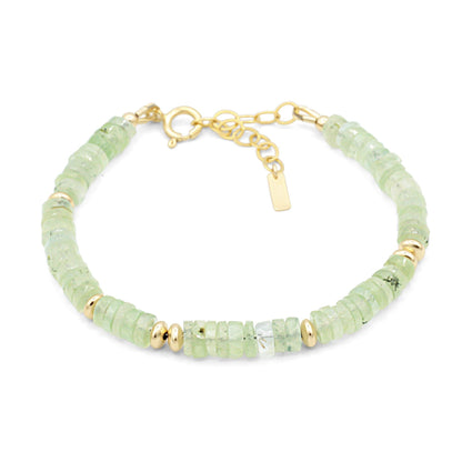 Prehnite glow bracelet featuring polished green stones from Earthly Abundance, showcasing smooth, rounded beads on an elastic band.