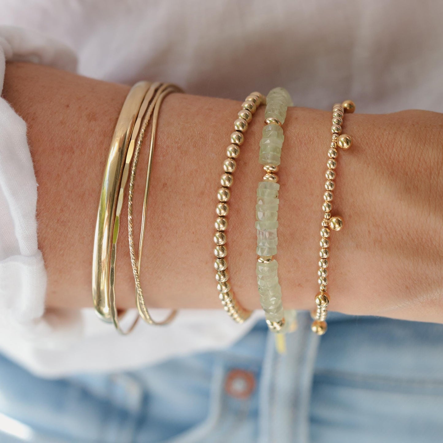 Prehnite Glow Bracelet by Earthly Abundance featuring smooth green prehnite beads on an elastic band.