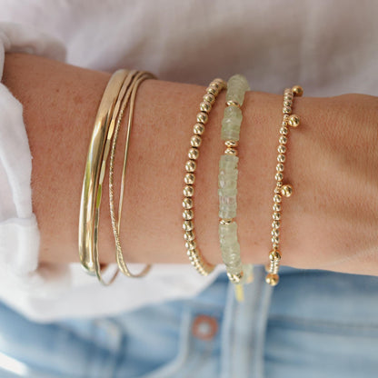 Prehnite Glow Bracelet by Earthly Abundance featuring smooth green prehnite beads on an elastic band.