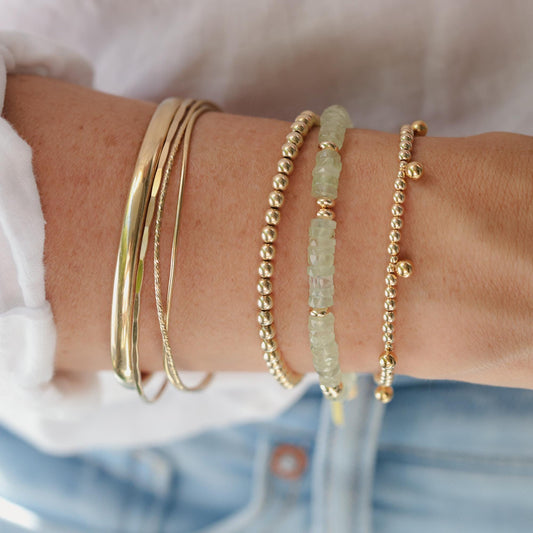 Prehnite Glow Bracelet by Earthly Abundance featuring smooth green prehnite beads on an elastic band.