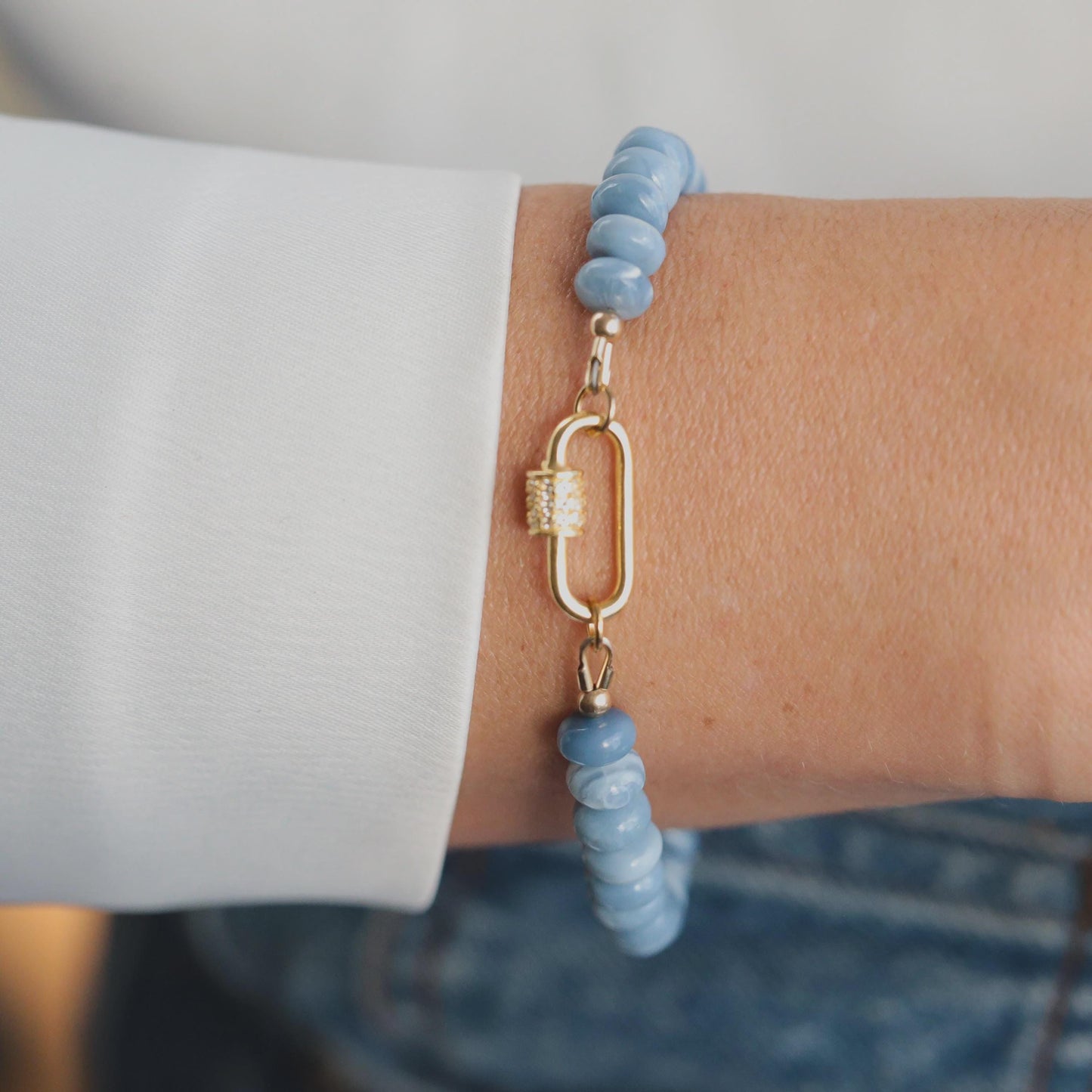 Blue Opal Topaz bracelet featuring polished gemstones on a delicate chain, styled with silver accents from Earthly Abundance.