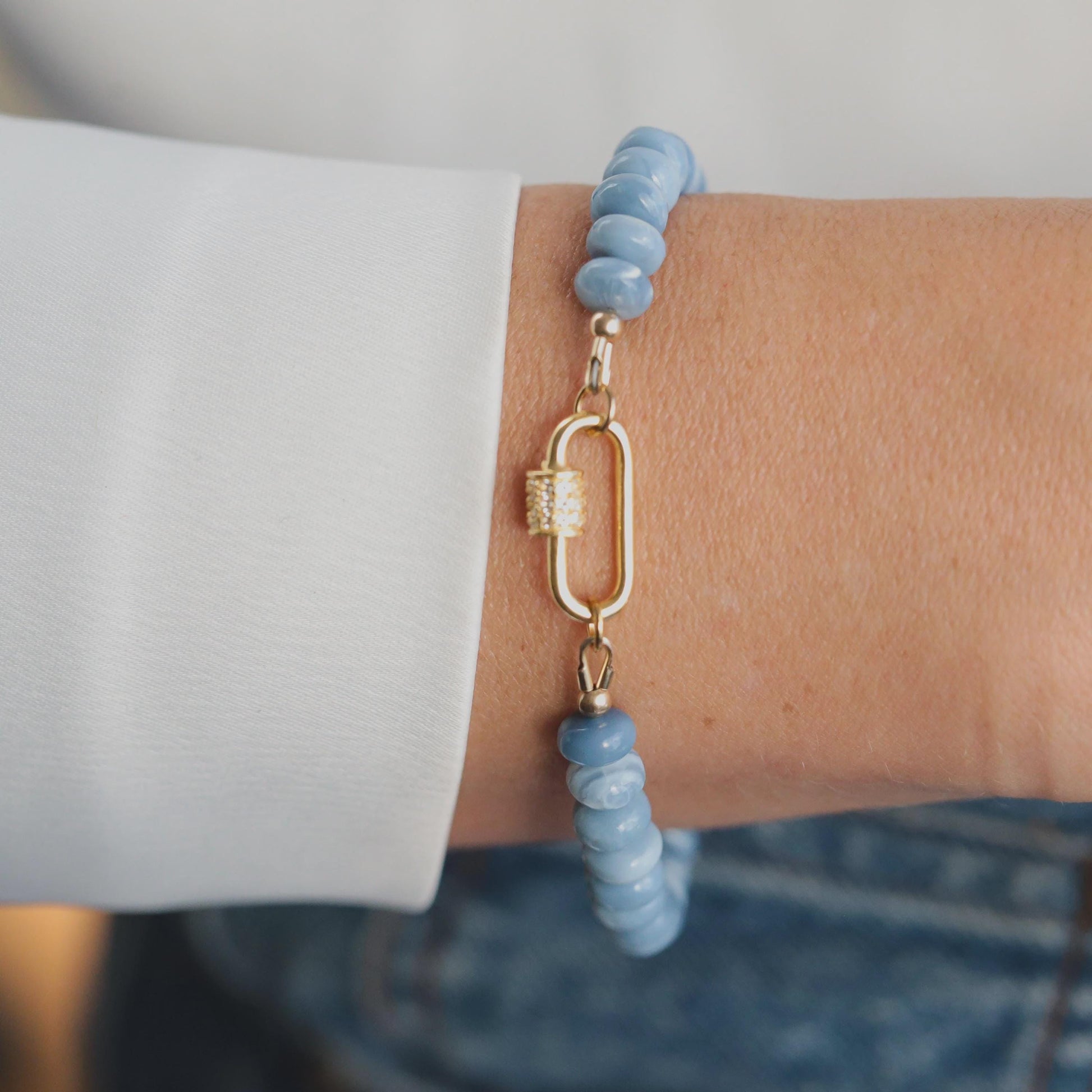 Blue Opal Topaz bracelet featuring polished gemstones on a delicate chain, styled with silver accents from Earthly Abundance.