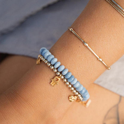 Blue opal topaz bracelet featuring vibrant blue gemstones on a silver chain, crafted by Earthly Abundance.