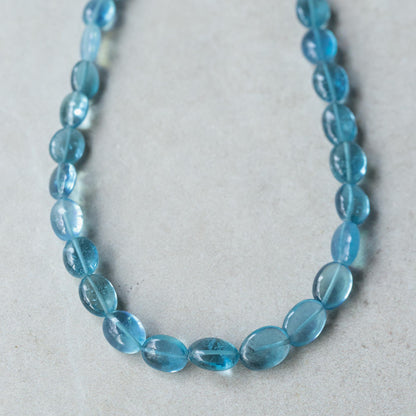 Bluewater Aquamarine Necklace by Earthly Abundance featuring a sparkling aquamarine pendant on a delicate silver chain.