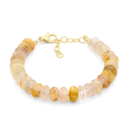 Golden rutilated quartz bracelet featuring golden needle-like inclusions, crafted by Earthly Abundance, on a neutral background.