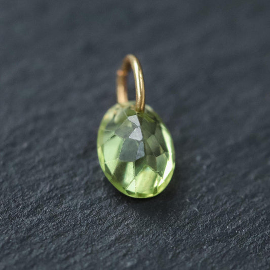 14K gold peridot pendant necklace by Earthly Abundance, featuring a vibrant green gemstone on a delicate chain.