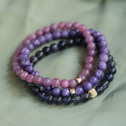 Earthly Abundance Gemma Ruby Bracelet with polished red ruby beads and silver clasp, displayed on a neutral background.