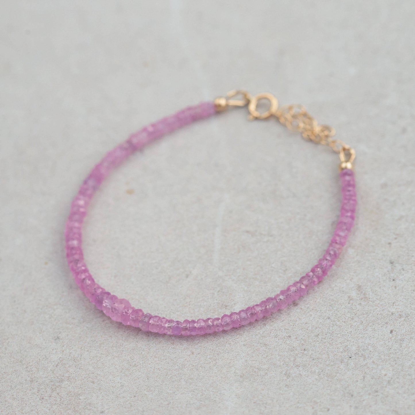 Baby pink sapphire bracelet in 14K gold from Earthly Abundance, featuring delicate pink sapphires and a refined design.