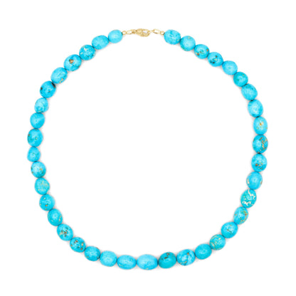 14K Sleeping Beauty turquoise pendant by Earthly Abundance featuring a vibrant blue gemstone set in a delicate gold pendant.