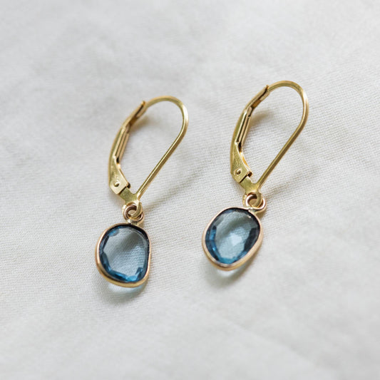 Swiss Blue Topaz leverback earrings in 14K gold with sparkling blue gemstones, handcrafted by Earthly Abundance.
