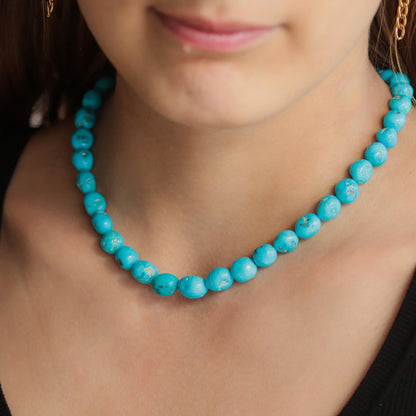 14K Sleeping Beauty turquoise ring by Earthly Abundance featuring a vibrant turquoise gemstone and elegant gold setting
