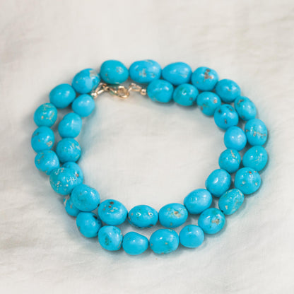 14K Sleeping Beauty turquoise pendant necklace by Earthly Abundance featuring a vibrant blue gemstone on a delicate chain.