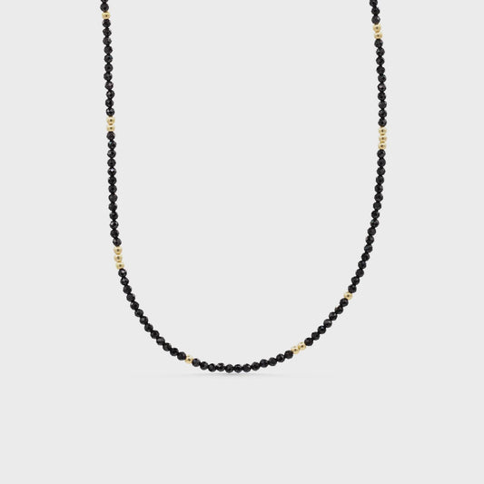 Earthly Abundance Midnight Muse Spinel Necklace featuring a sparkling black spinel pendant on a delicate chain.