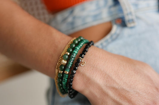 Malachite Heishi bracelet from Earthly Abundance featuring smooth green stone beads on an elastic band.