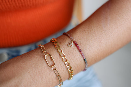 Earthly Abundance Jewelry paperclip bracelet featuring sleek, minimalistic design with interconnected links on a neutral background.