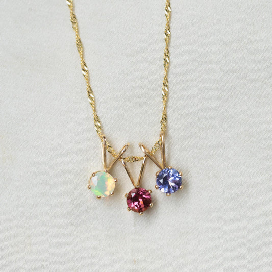Ethiopian opal necklace by Earthly Abundance featuring a striking, colorful opal pendant on a delicate chain.