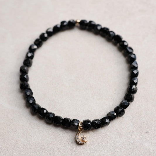 Black Tourmaline Moon and Star bracelet by Earthly Abundance featuring black gemstone beads and moon and star charms.