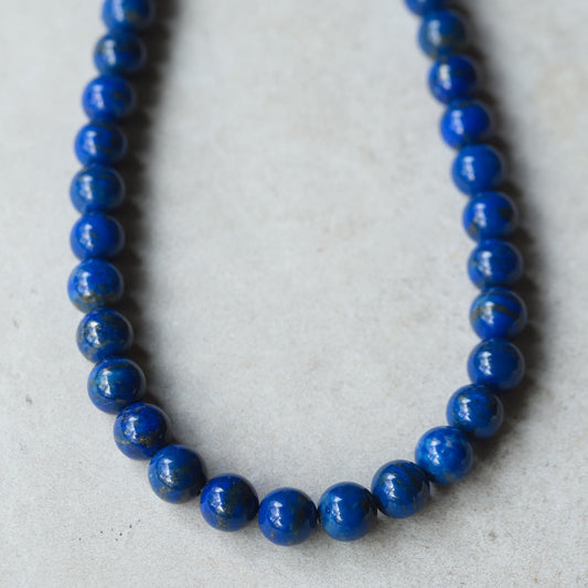 Royal Lapis Necklace featuring 10mm Lapis Lazuli beads from Earthly Abundance, showcasing a vibrant blue gemstone jewelry piece.