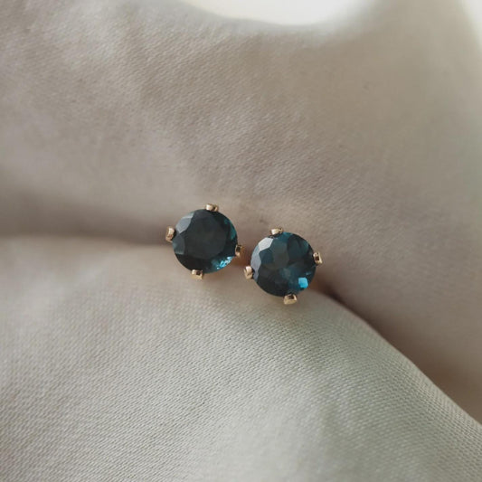 14K gold-filled gemstone stud earrings with 4mm round stones, featuring Earthly Abundance branding and classic jewelry style.