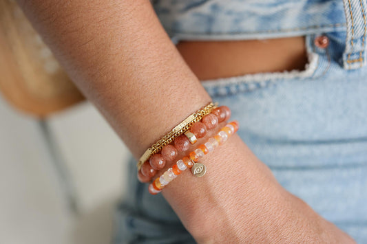 Fire opal evil eye bracelet by Earthly Abundance featuring vibrant orange fire opal beads and protective evil eye charm.