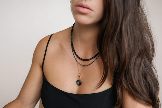 Black Ethiopian Opal beaded necklace featuring smooth, round beads with vibrant iridescent colors, crafted by Earthly Abundance.