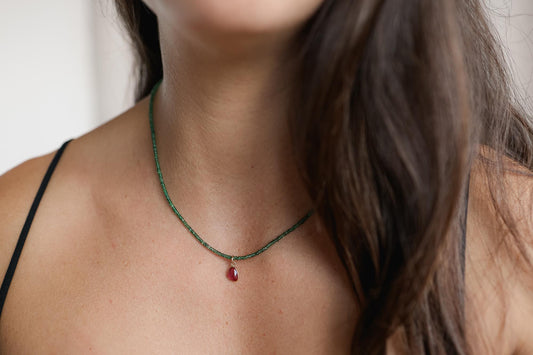Zambian emerald and pink tourmaline necklace featuring vibrant gemstones set in a delicate gold chain.