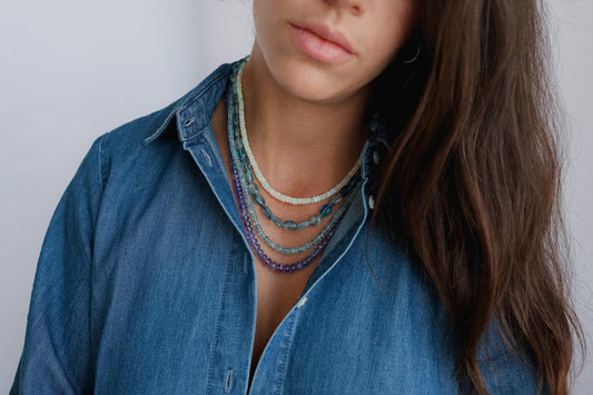 Elegant Tanzanite smooth rondel necklace featuring 14K gold chain, showcasing vibrant blue-purple gemstones from Earthly Abundance.