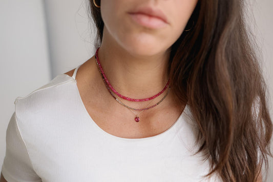 Earthly Abundance Tundra Garnet Necklace featuring a striking garnet pendant on a delicate chain, showcasing rich red gemstone.