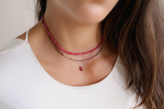 Pink tourmaline necklace pendant in 14K gold, featuring a vibrant pink gemstone on a delicate chain.
