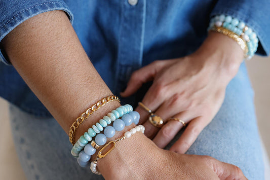Sky blue Larimar bracelet featuring polished stones, crafted by Earthly Abundance, displayed with multiple Larimar beads.