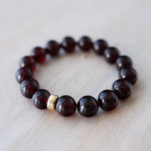 Earthly Abundance garnet bracelet with 10mm round garnet beads, showcasing a stylish and natural jewelry piece.